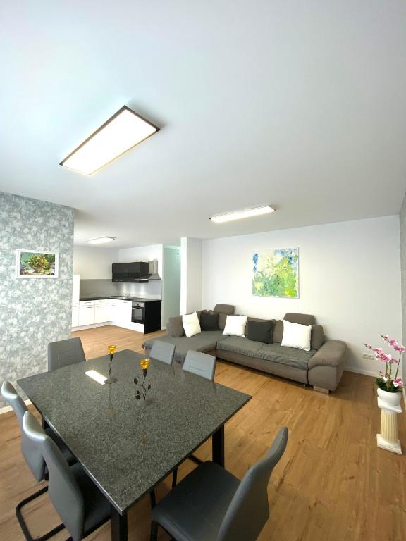 a living room with a table and a couch at Naturnahe Wohnung in Zettingen A in Zettingen