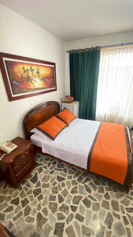 Postel nebo postele na pokoji v ubytování Hotel Tequendama