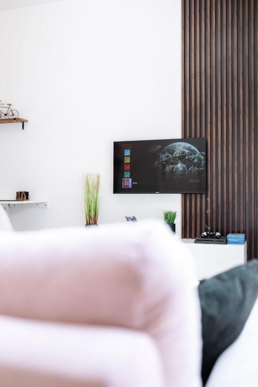 a living room with a tv on a wall at Novostavba v centre + parking in Banská Bystrica