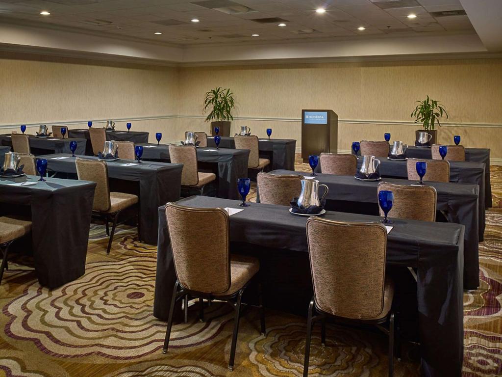 a conference room with tables and chairs and sidx sidx sidx at Sonesta Atlanta Airport North in Atlanta