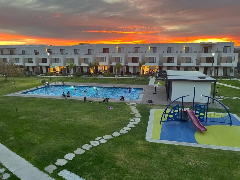 a large swimming pool with a slide in a yard at Casa Cordova in Alpuyeca
