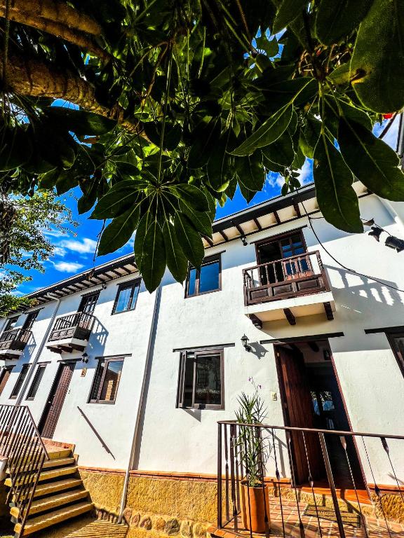 a white building with stairs in front of it at Serena Morena in Villa de Leyva