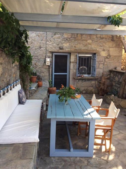 a blue table and chairs on a patio at Summer Stoned Maisonette in Kondiás