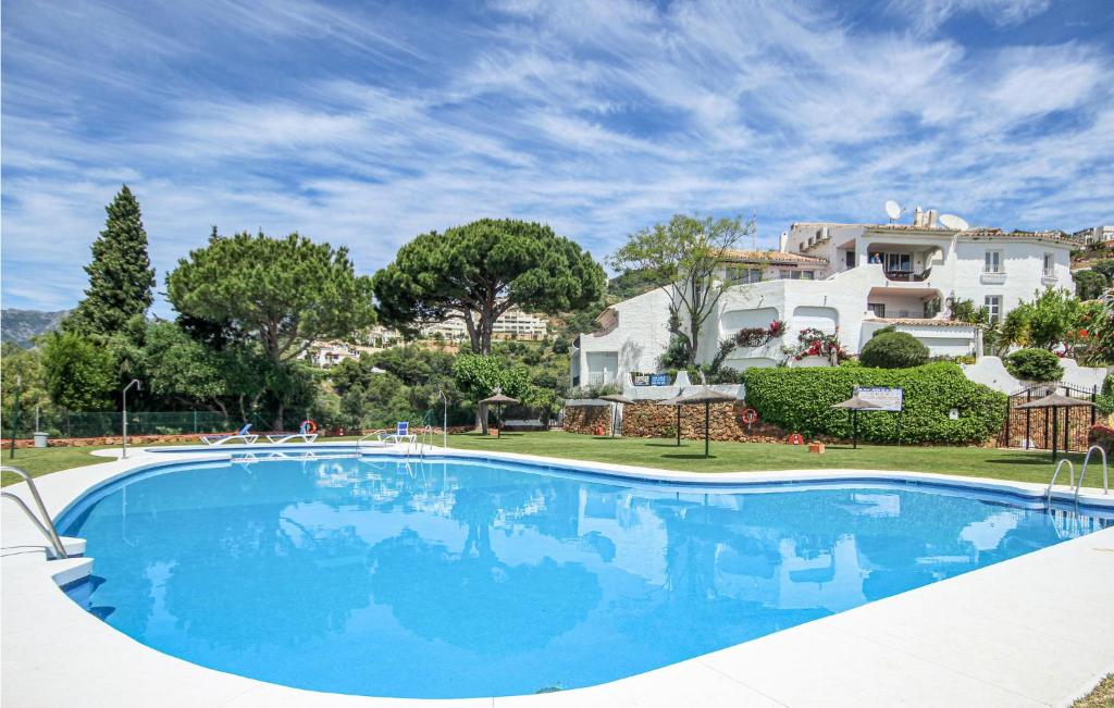 a large swimming pool in front of a house at Nice Home In Marbella in Marbella