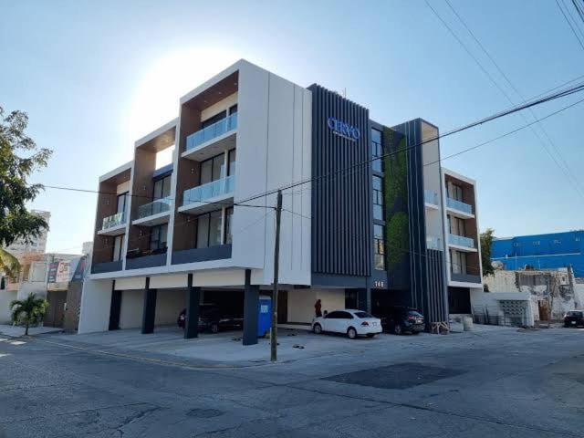 a building with a car parked in front of it at Mazatlán Cervo vacacional in Mazatlán