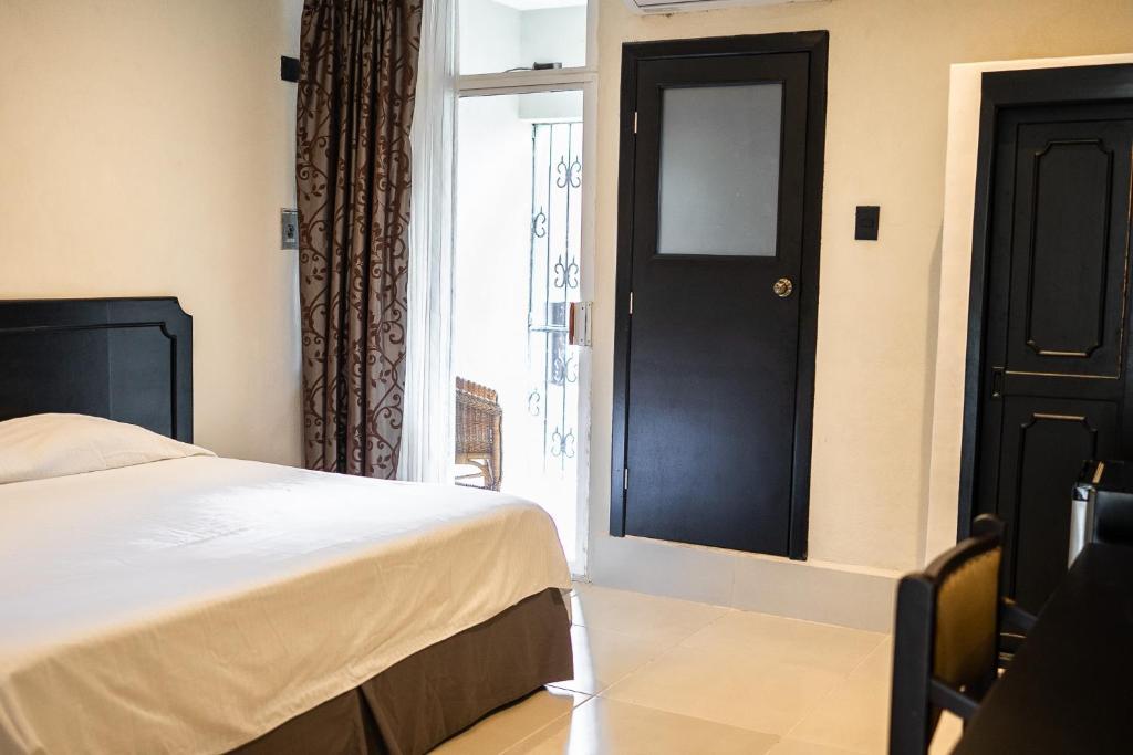 Postel nebo postele na pokoji v ubytování Hotel María de la Luz