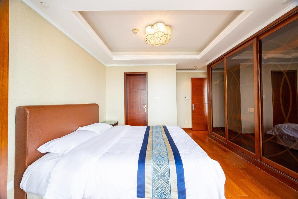 Postel nebo postele na pokoji v ubytování Qingdao Elegant Central Apartment