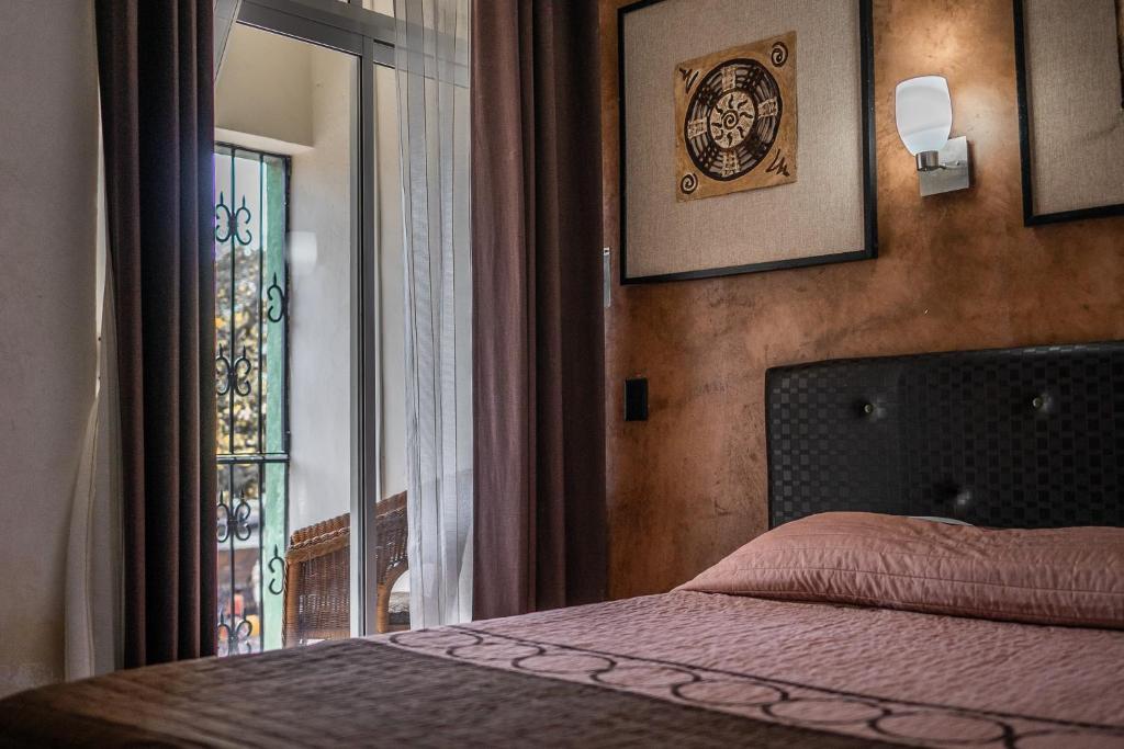 Postel nebo postele na pokoji v ubytování Hotel María de la Luz