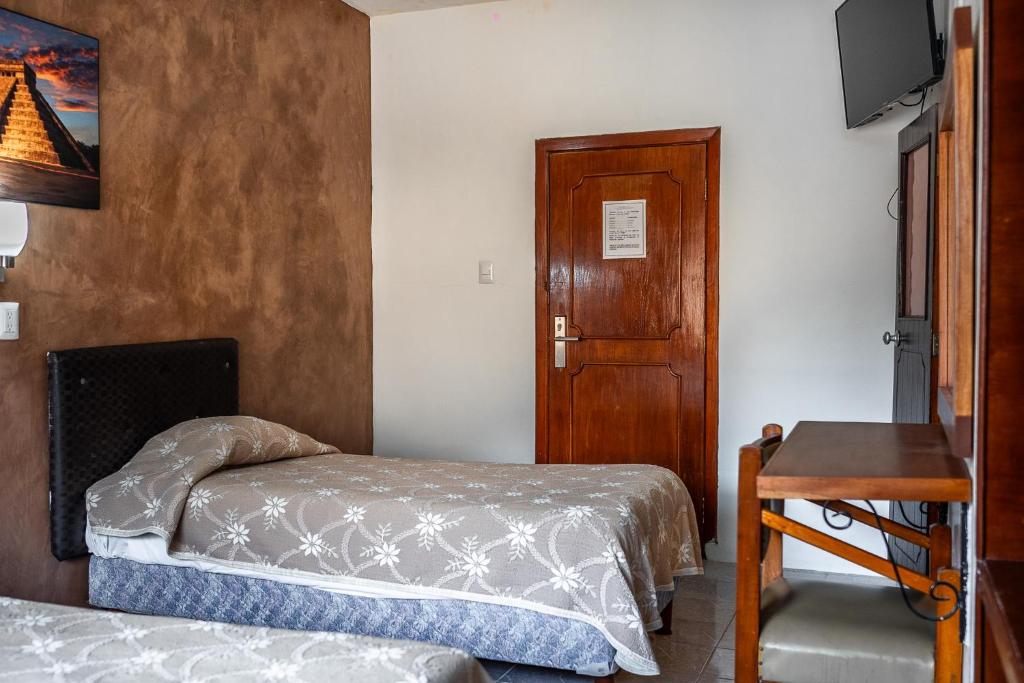 Postel nebo postele na pokoji v ubytování Hotel María de la Luz