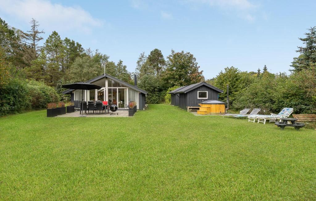 a cabin in a field with a grass yard at Cozy Home In Glesborg With Wifi in Glesborg