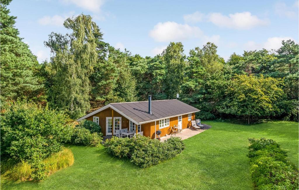 an orange house in the middle of a yard at Holiday Home Højby 9 in Lumsås