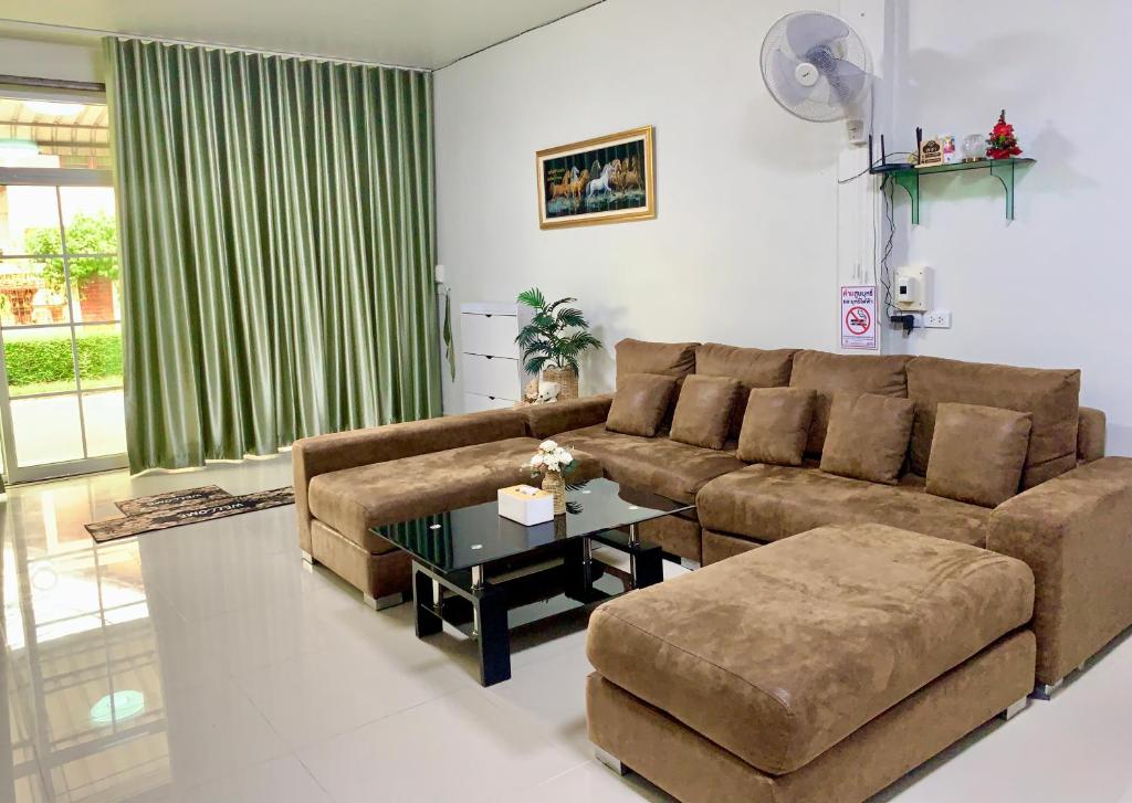 a living room with a couch and a table at BAAN OZONE HY2 in Hat Yai