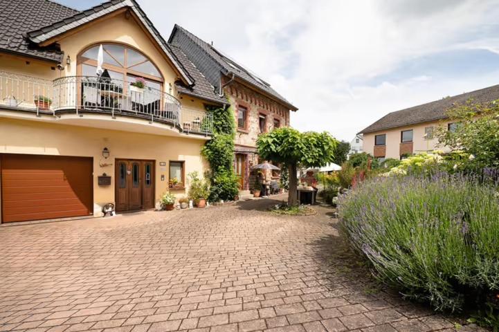 a brick driveway in front of a house at Ferienwohnung Lilly in Eitelborn
