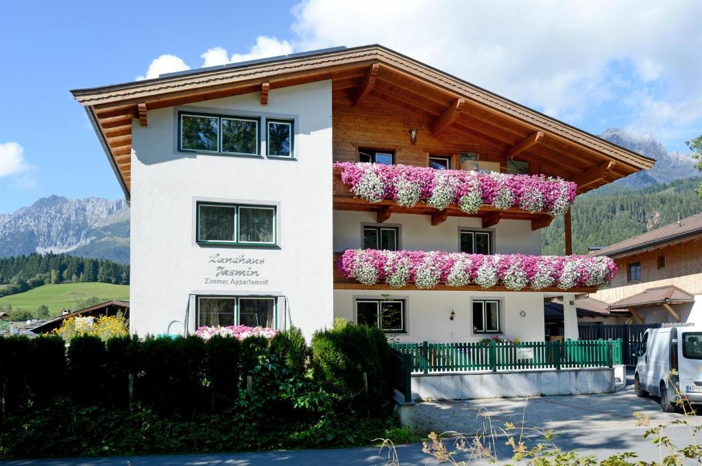 a house with flowers on the balcony at Haus Jasmin in Ellmau