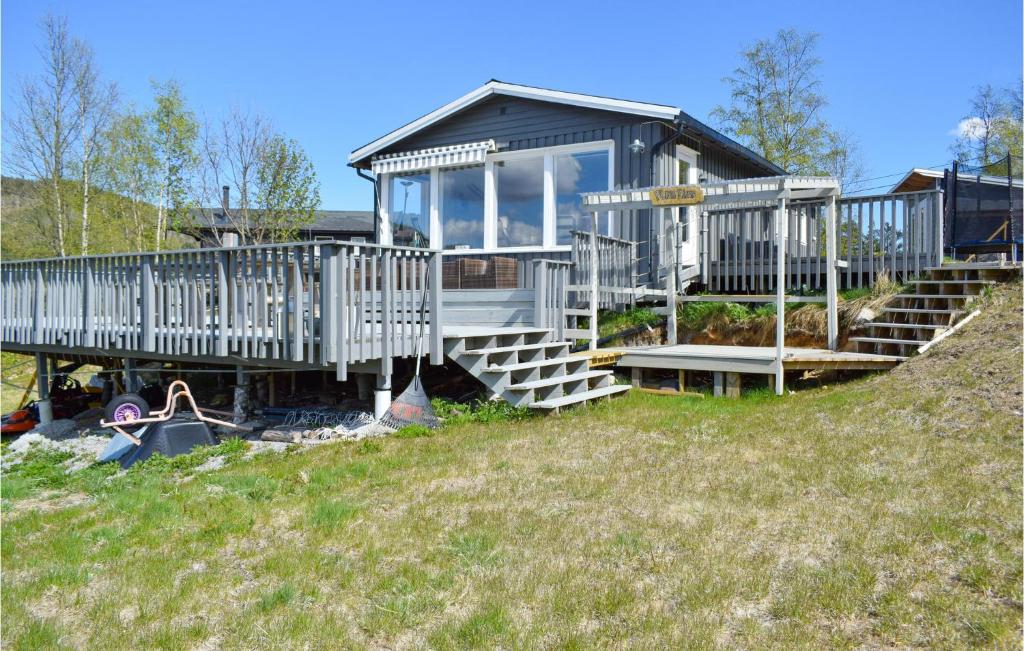 a house on a hill with a large deck at 5 Bedroom Pet Friendly Home In Eiken in Eiken