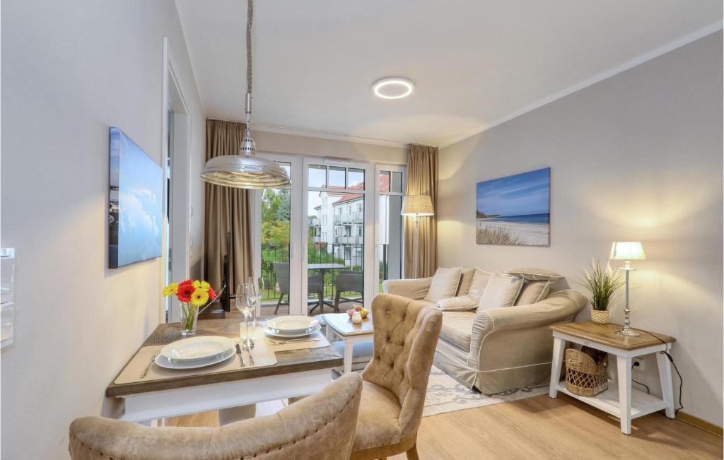 a living room with a couch and a table at Baltischer Hof Apartment 35 in Boltenhagen