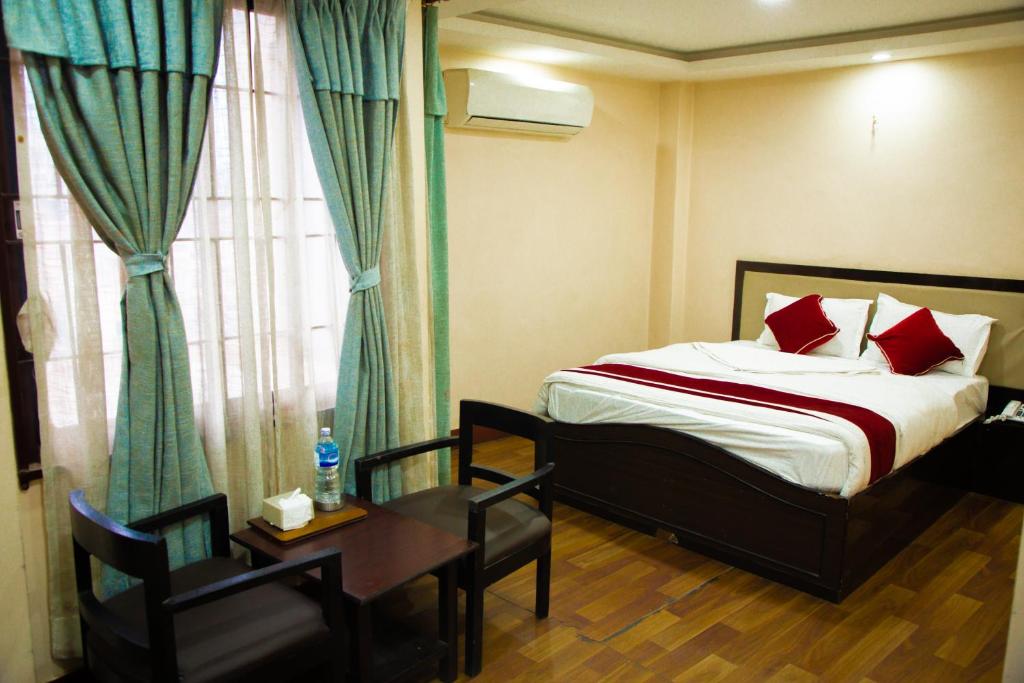 Postel nebo postele na pokoji v ubytování Hotel paradise valley view Pvt ltd