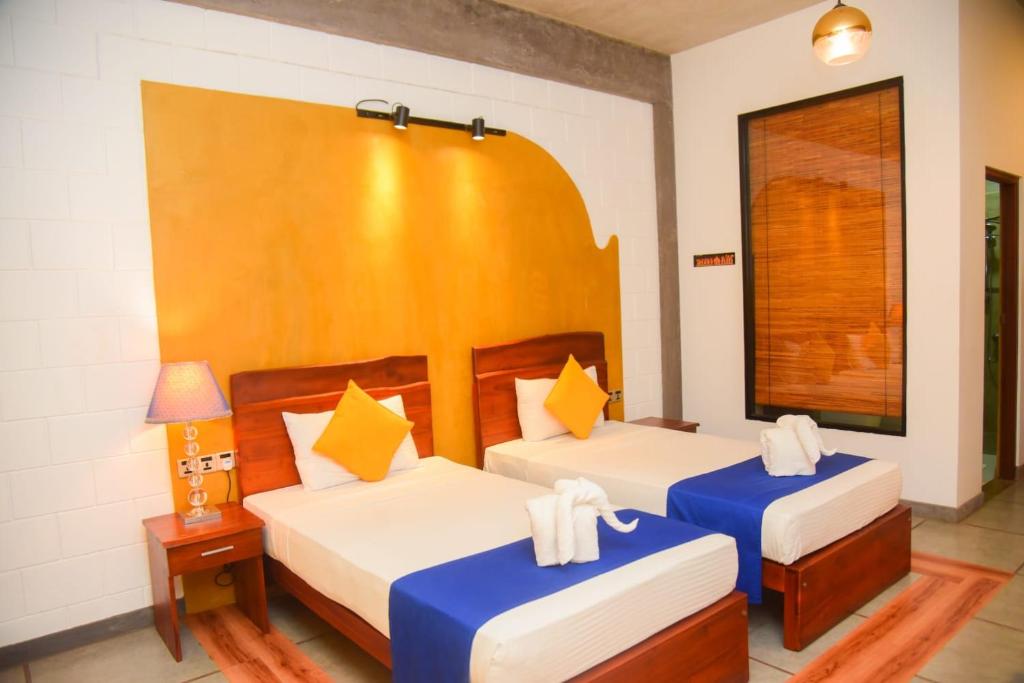 Postel nebo postele na pokoji v ubytování Royal Tusker Hotel