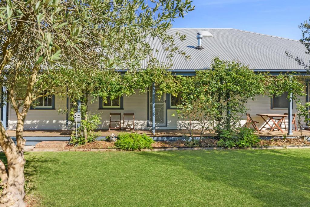 a house with a lawn in front of it at Charming Heritage Haven 'Ye Olde St Leonards Hotel' 3 Bedroom, Pet Friendly, Fire Place, Free Wifi & Netflix, Walk to Beach & Shops in Saint Leonards