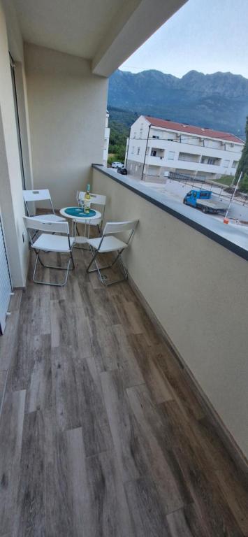a balcony with a table and chairs on a building at Zira2 in Kotor
