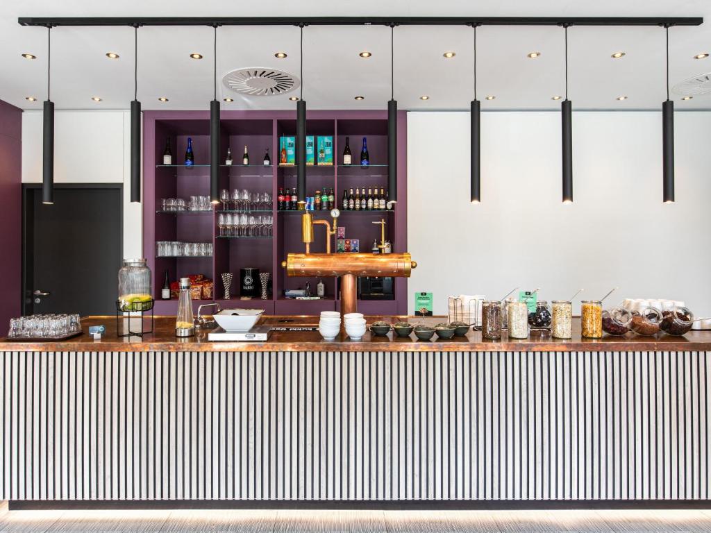a bar in a restaurant with a counter top at B&B Hotel Hamburg-Airport in Hamburg