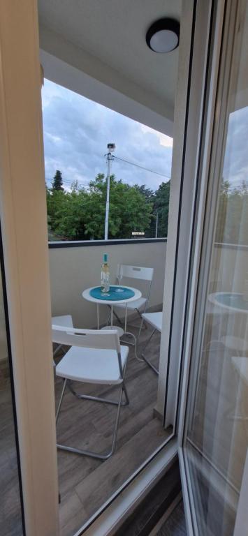 a patio with a table and chairs on a balcony at Zira2 in Kotor