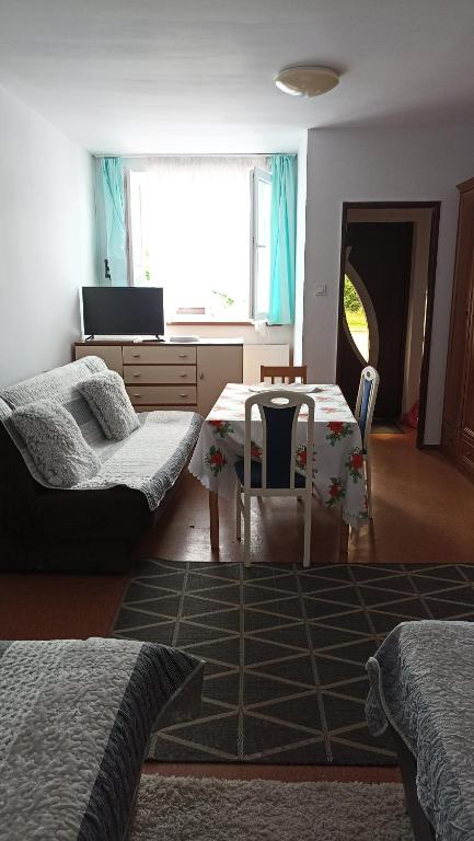 a bedroom with a desk and a table with a chair at Turystyczny ul Bałtycka 2 in Stare Bielice