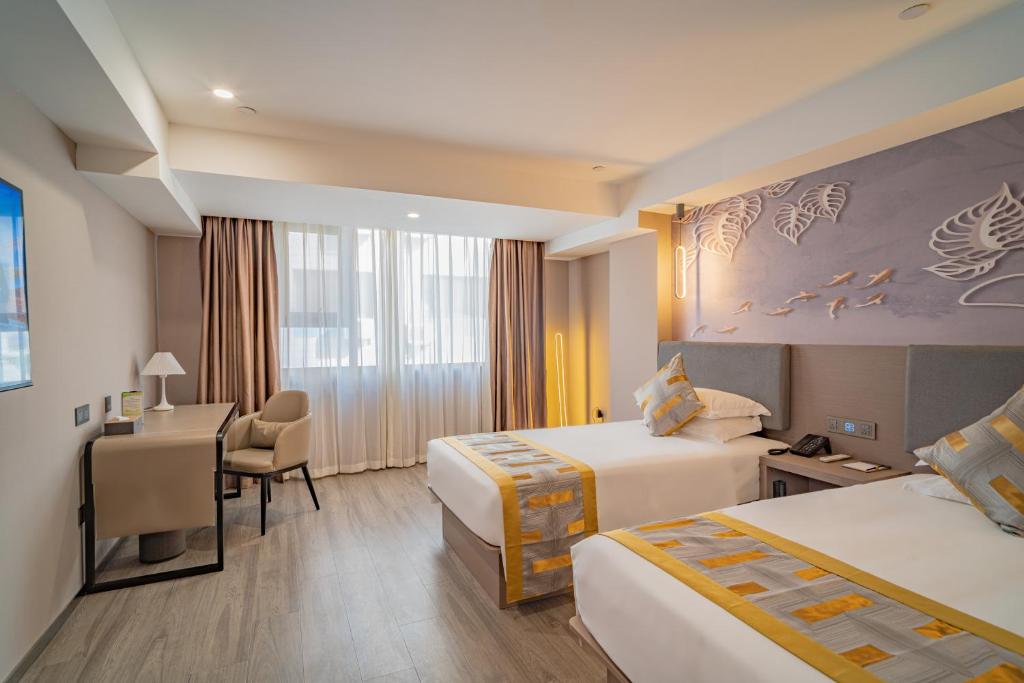 Postel nebo postele na pokoji v ubytování Ruilan Grandyard Hotel