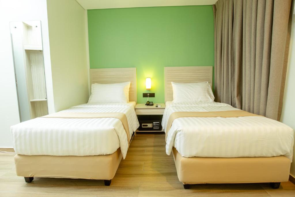 Postel nebo postele na pokoji v ubytování Hamersons Hotel CDO