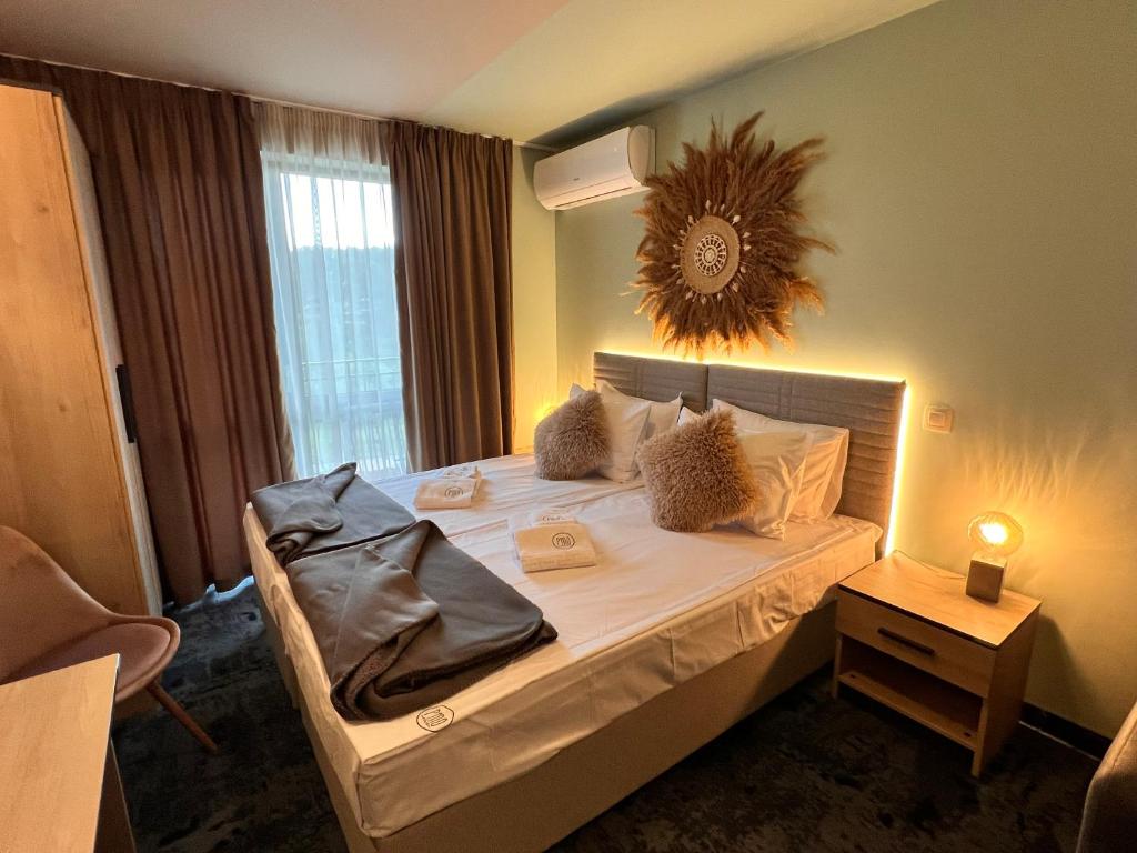 a bedroom with a bed with a mirror on the wall at Pino - Villa, Casa, Cucina е Terrazza in Albena