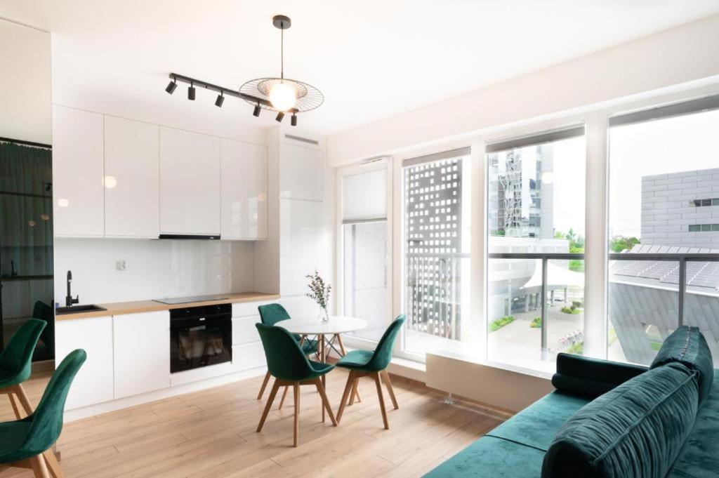 salon z kanapą i stołem z krzesłami w obiekcie Golden Apartments-Sok15 w mieście Katowice