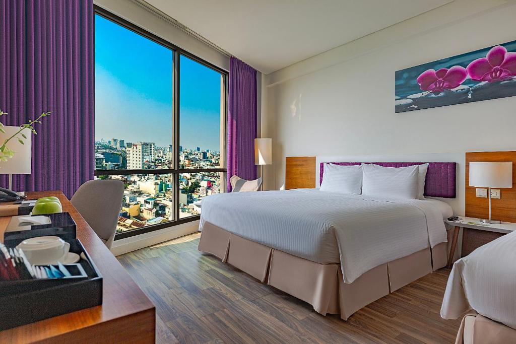 Giường trong phòng chung tại Vanda Hotel
