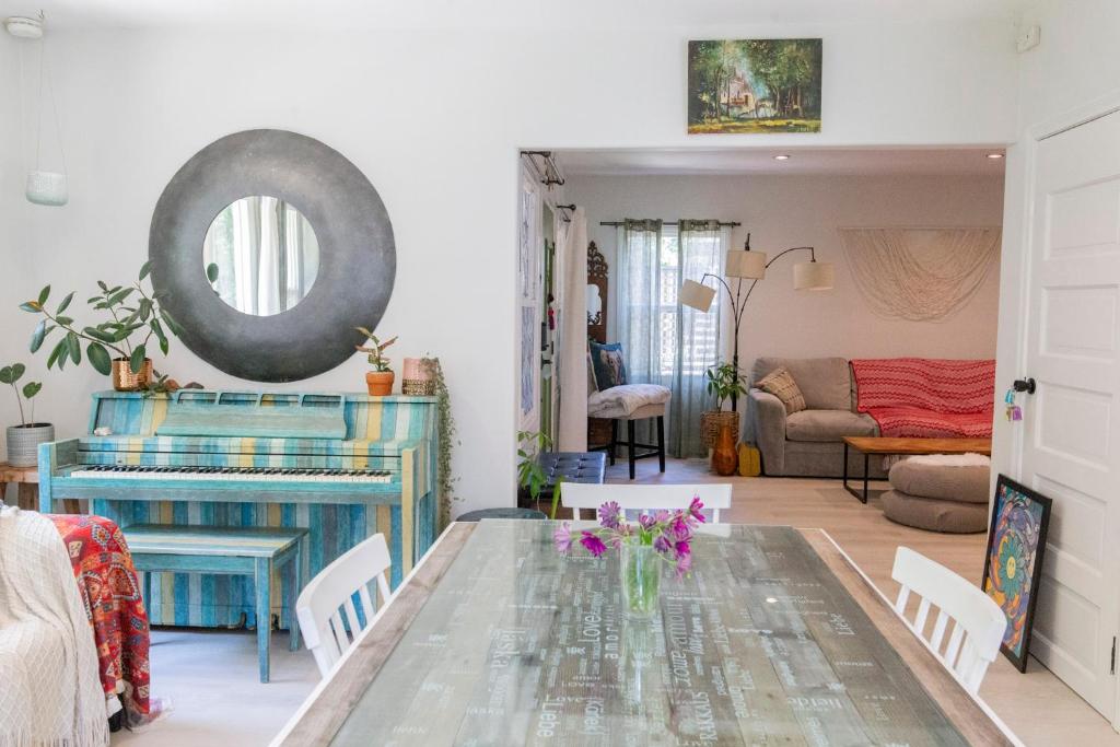 a living room with a table with flowers on it at Oasis Hollywood in Los Angeles