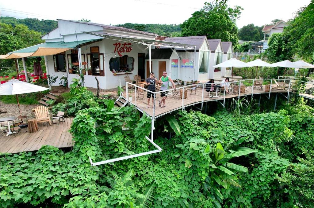 an overhead view of a restaurant with people sitting on a deck at Retro Khe Sanh in Lao Bao