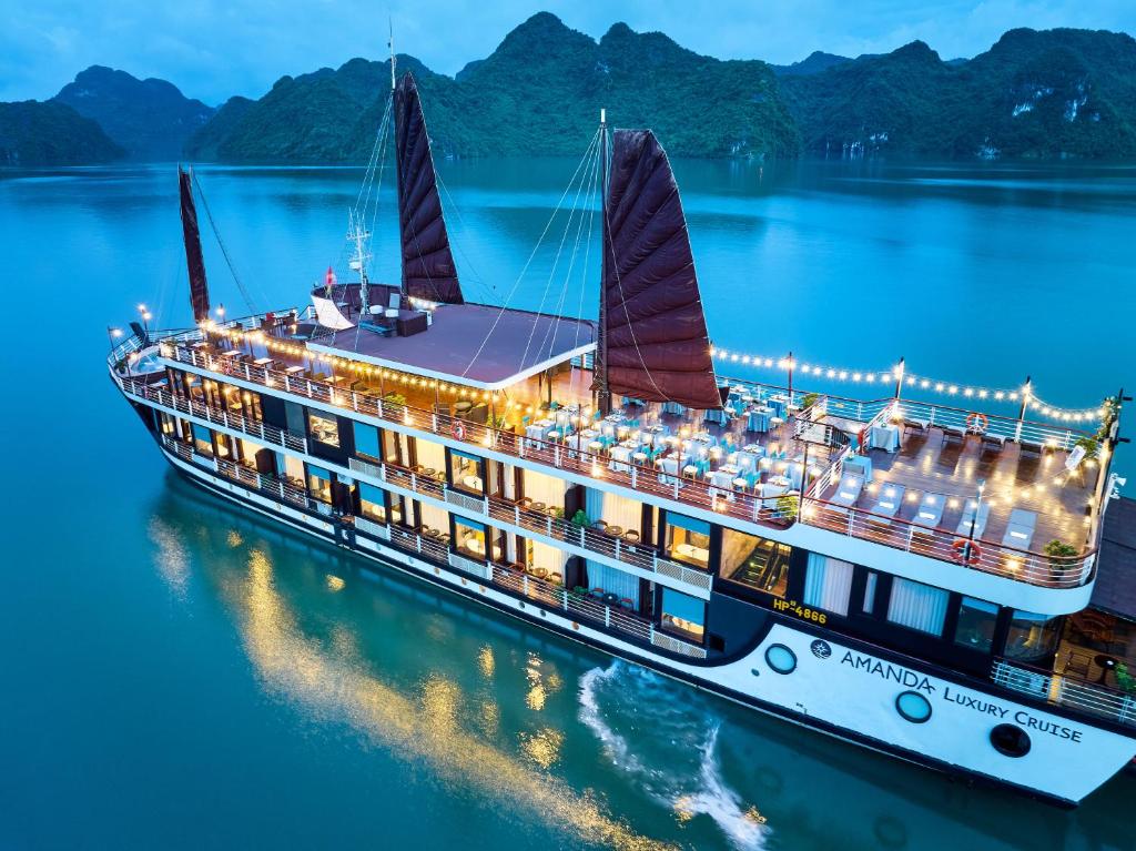 a cruise ship in the water at night at Amanda Luxury Cruise in Ha Long