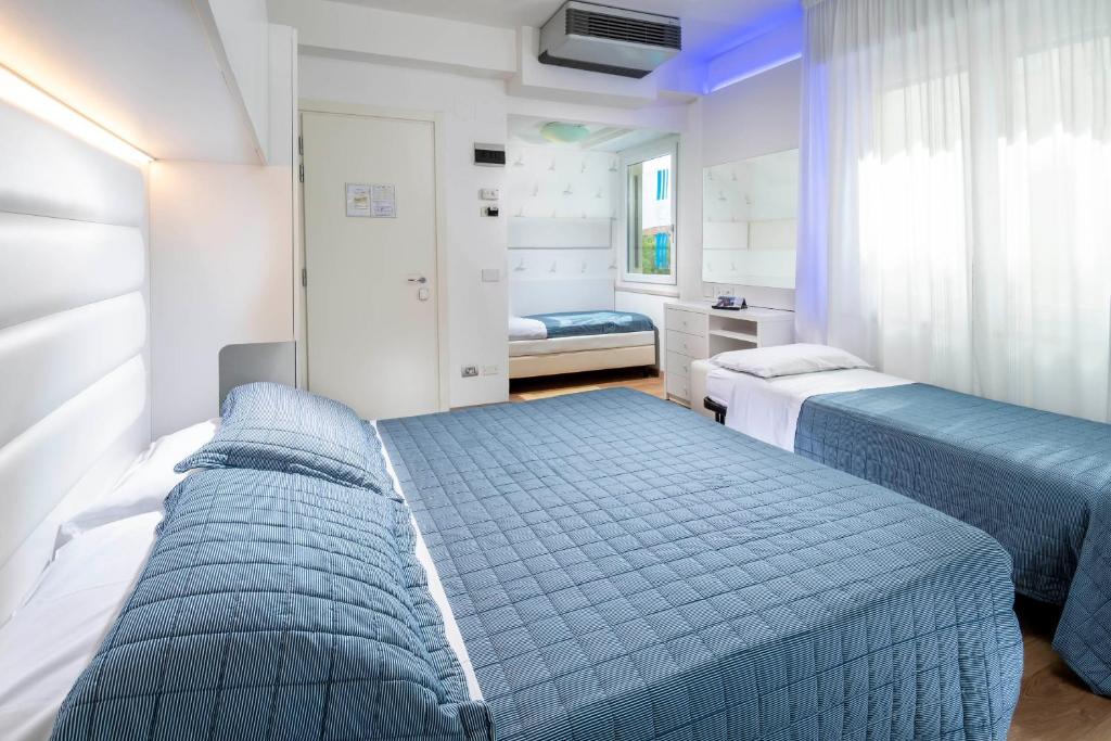 Postel nebo postele na pokoji v ubytování Hotel Albatros