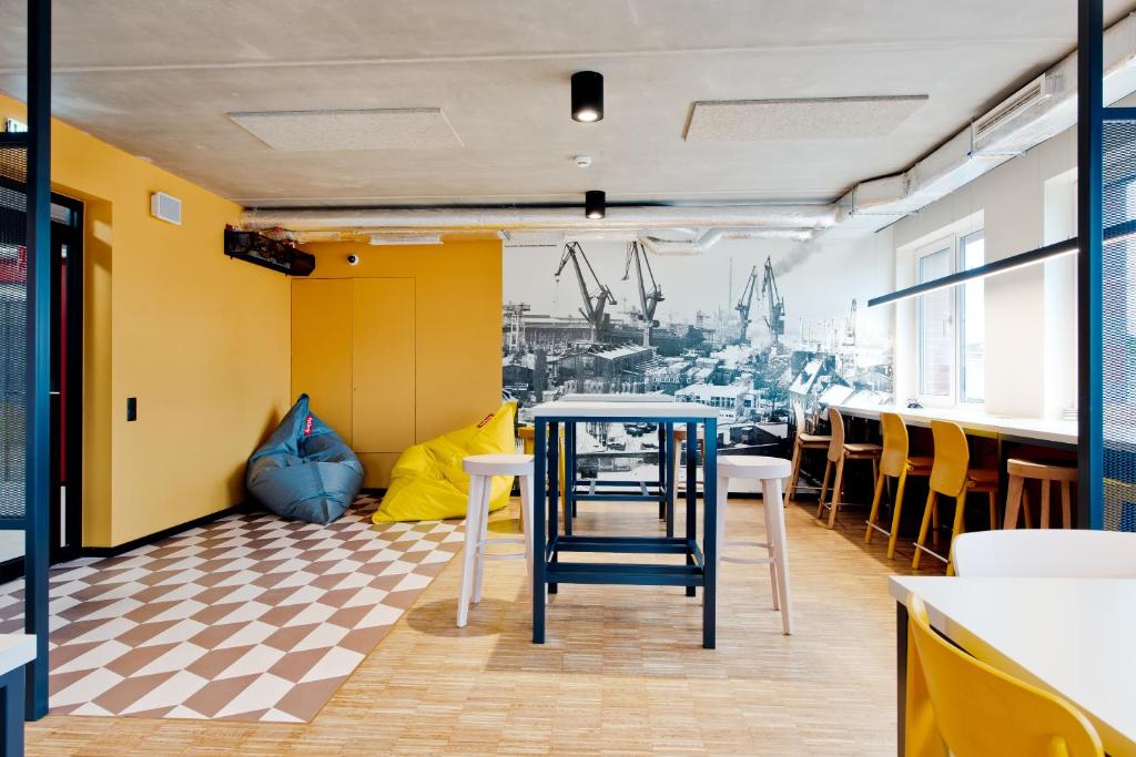 a restaurant with a table and chairs in a room at MILESTONE by Tribera Gdańsk Center in Gdańsk