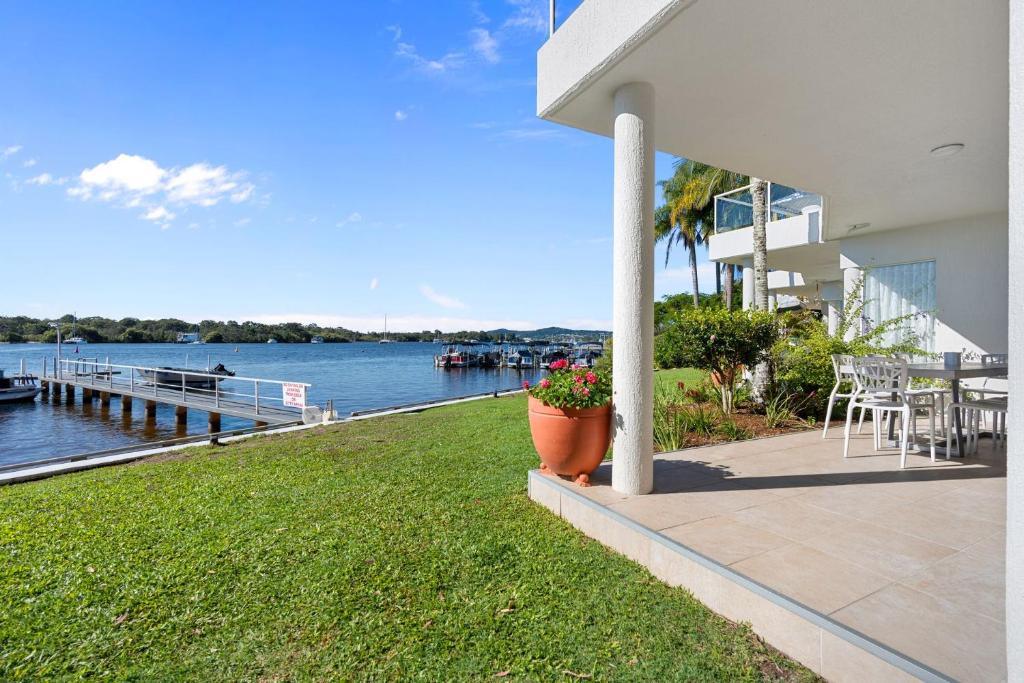 a porch of a house with a view of the water at Noosa River Gardens 1 Hilton Terrace 76 in Tewantin