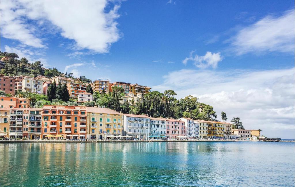 a group of buildings on the shore of a body of water at Villa Arduino in Santa Liberata