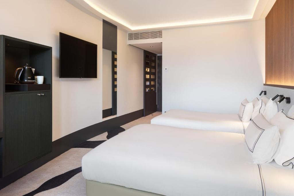 Кровать или кровати в номере Hotel Meliá Bilbao