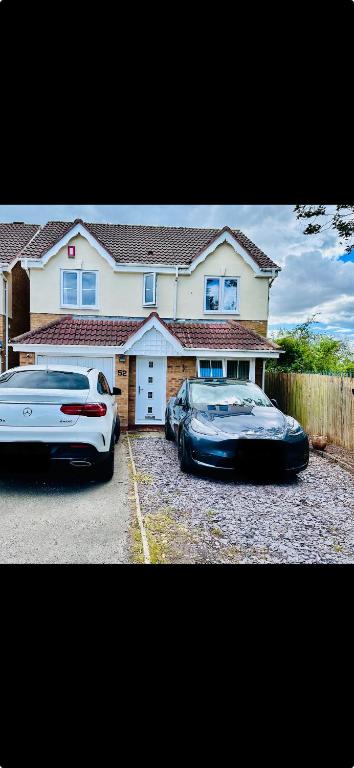 two cars parked in front of a house at Luxury 4 bed house in Coventry in Coventry
