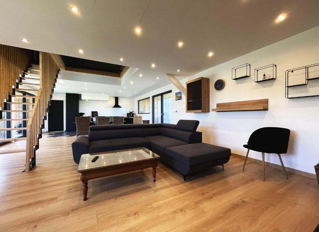 a living room with a couch and a coffee table at maison Porzh Loaz. in Plouézec
