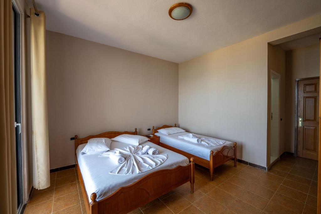 Postel nebo postele na pokoji v ubytování Hotel Nika Radhime