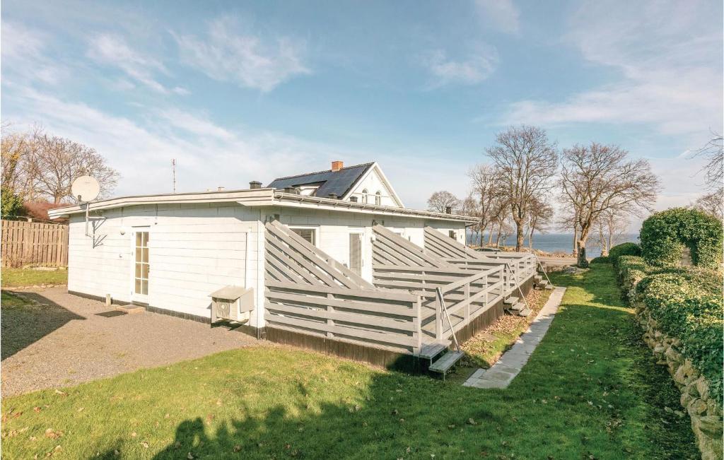 a white house with a fence around it at Two-Bedroom Apartment In Allinge in Allinge