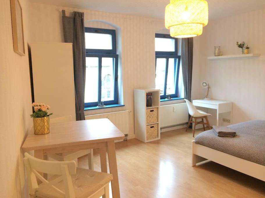 a bedroom with a desk and a bed and a table at Studio in It District Neustadt Louisenstraße in Dresden