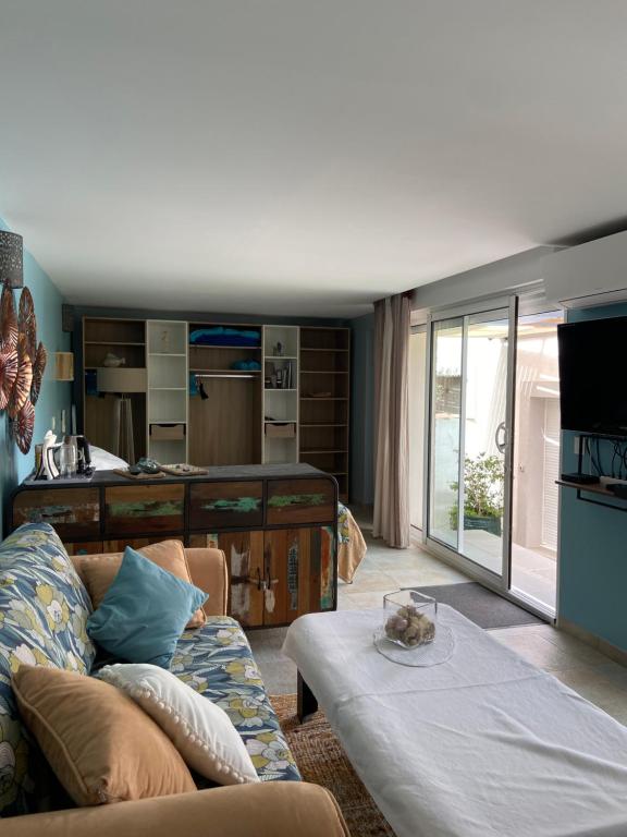 a living room with a couch and a table at Les terrasses des Anthenors in La Redonne