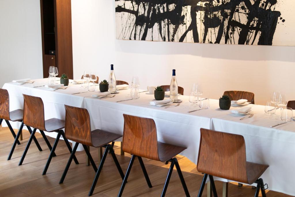 a long white table with chairs and bottles of wine at Grand Hôtel Champs-Elysées in Paris
