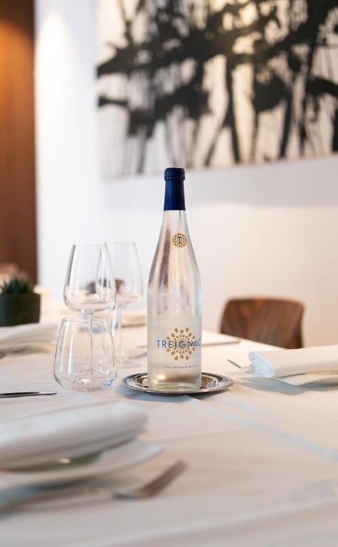 a bottle of wine sitting on a table with two glasses at Grand Hôtel Champs-Elysées in Paris