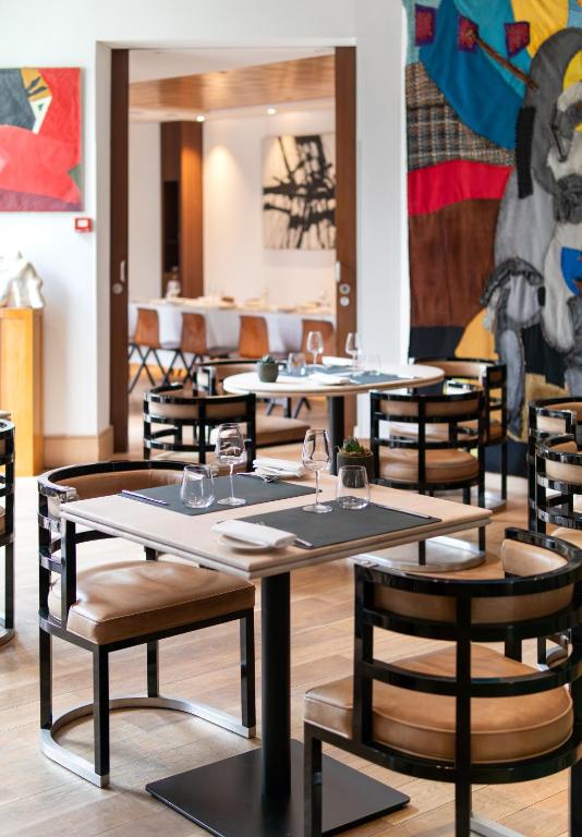 a row of tables and chairs in a restaurant at Grand Hôtel Champs-Elysées in Paris