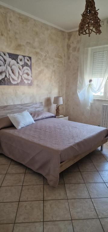 a bedroom with a large bed in a room at MARY ROSE - Locazione Turistica in Brindisi